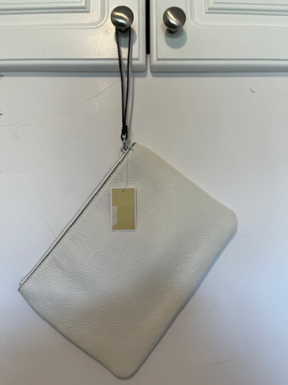 Michael Kors white leather wristlet.